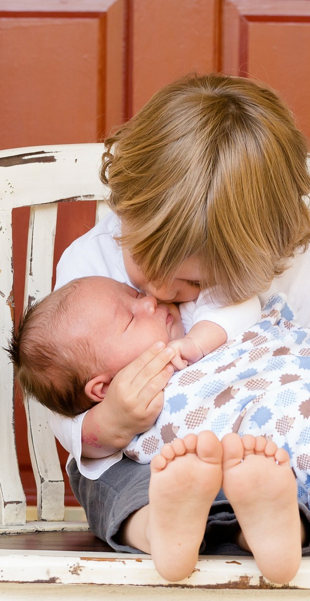 Can co-breastfeeding my first child and my newborn affect colostrum production?